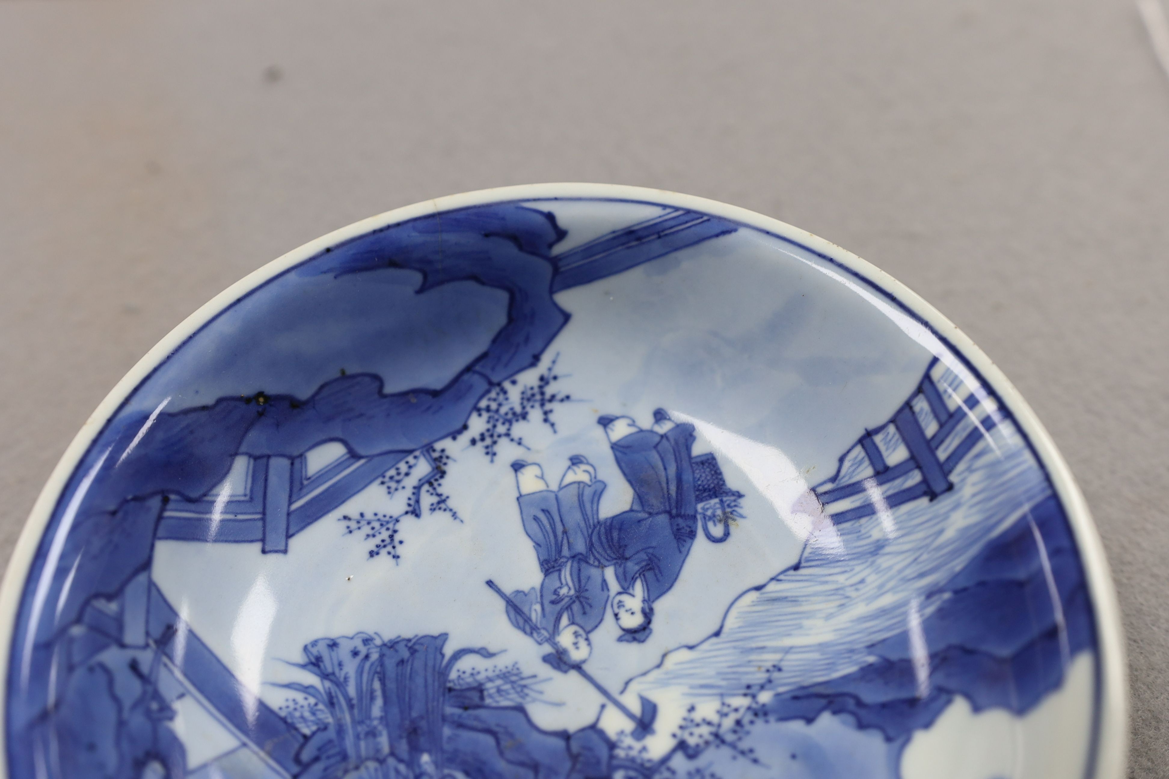 NB BOTH WITH HAIRLINE CRACKS A pair of Chinese blue and white small dishes, Kangxi six character marks and of the period (1662-1722), 15.7cm and 15.8cm diameter, foot later pierced, hairline cracks